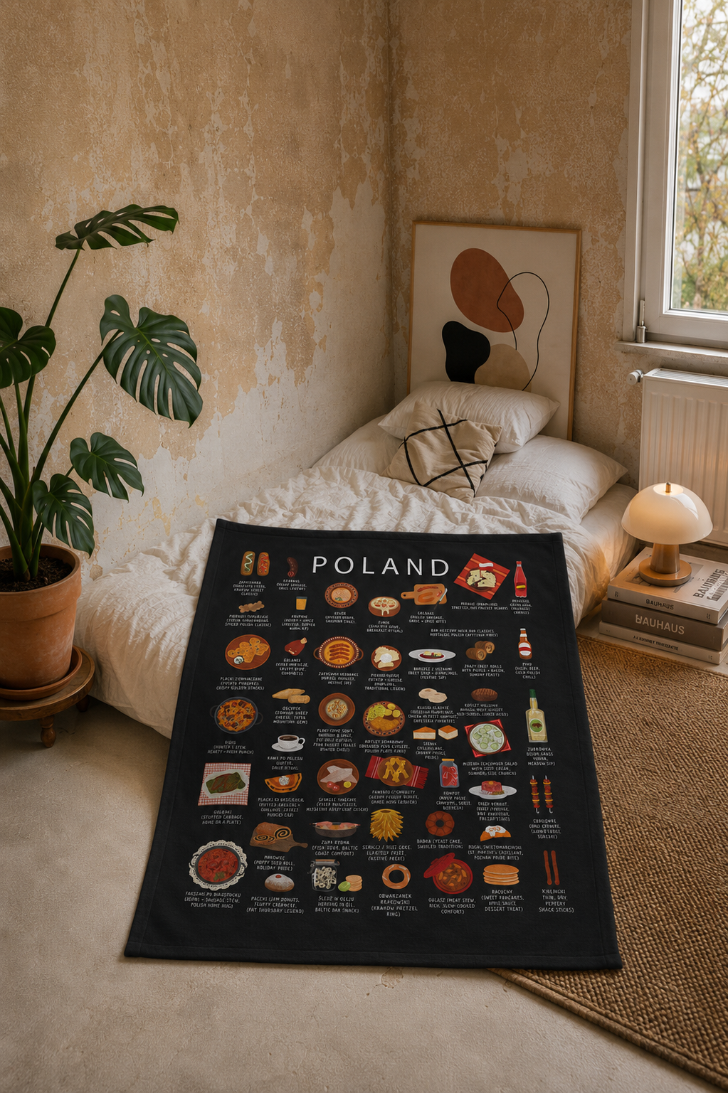 Black Poland food blanket styled on a bed in a warm, neutral bedroom