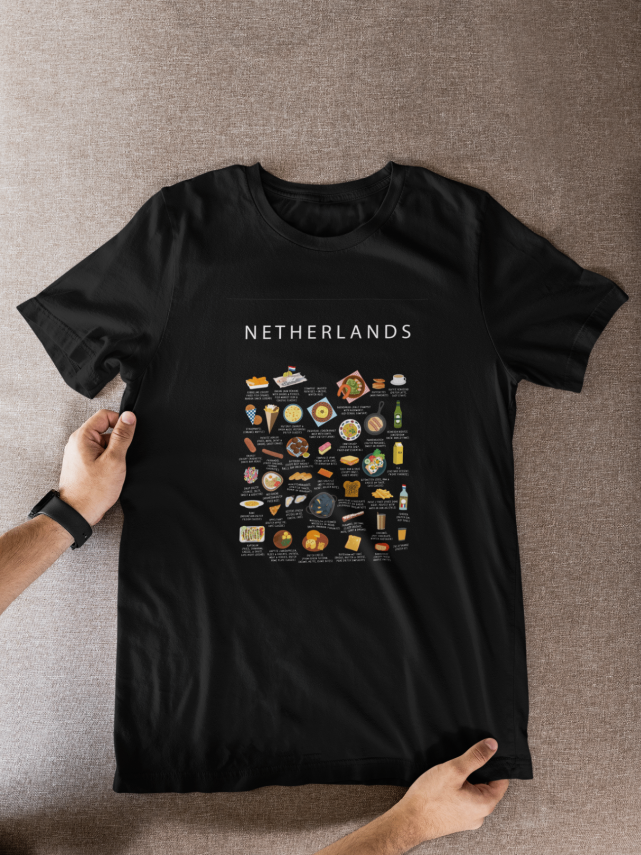Black Netherlands food t-shirt styled flat against textured neutral fabric