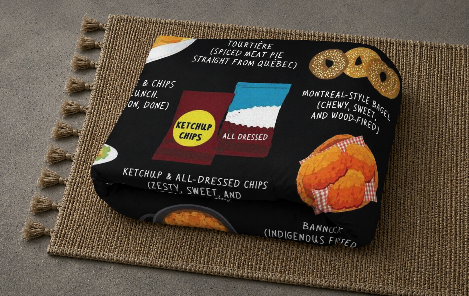 Detail of the Canada food blanket folded on a jute mat showing Montreal bagel and tourtière illustrations