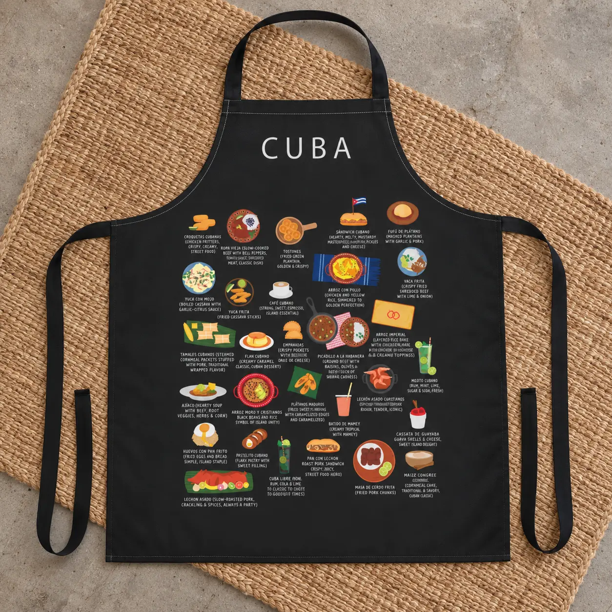 Black Cuba food apron styled flat on a woven natural rug