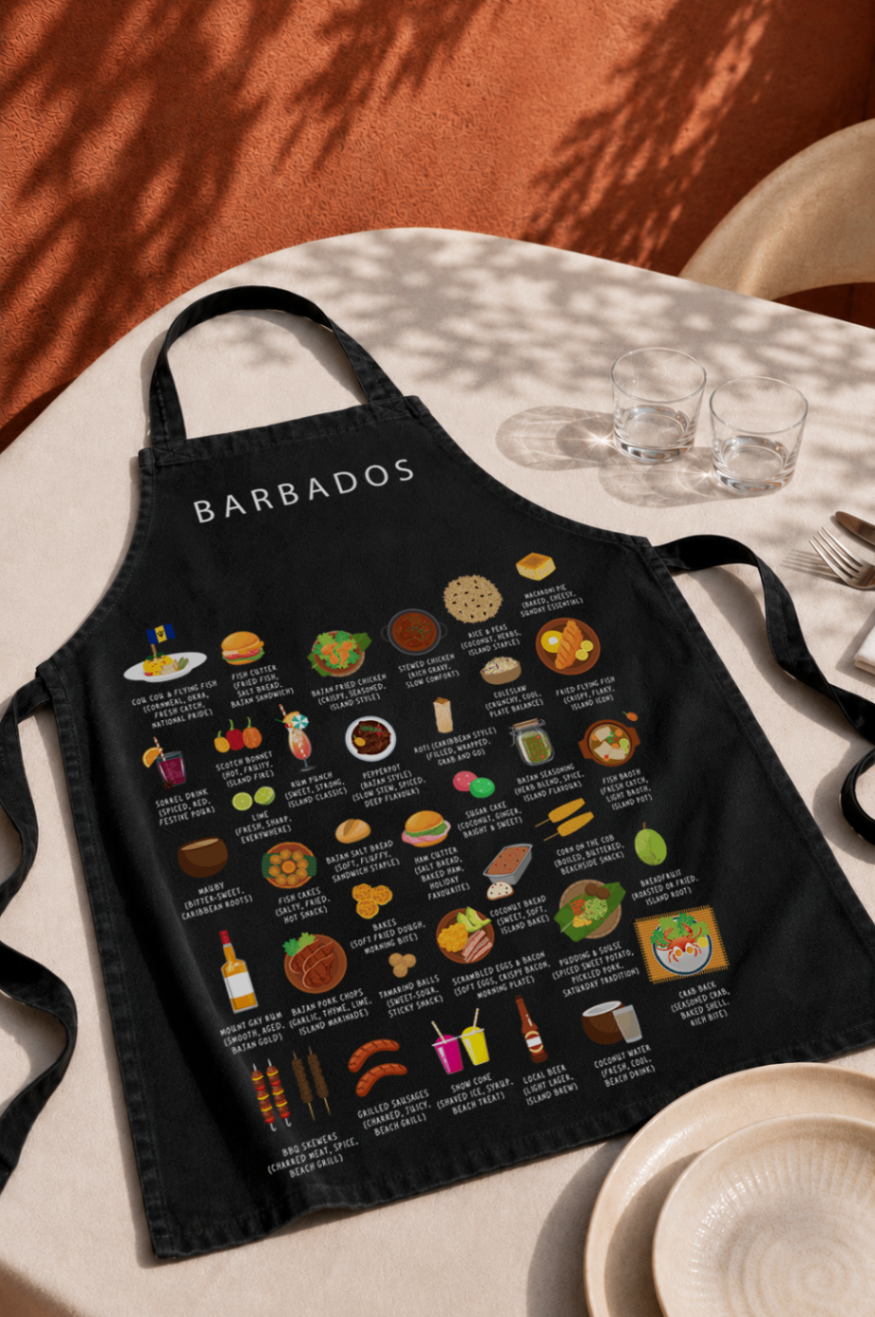 Black Barbados food apron laid on a stone table under dappled shade with terracotta walls