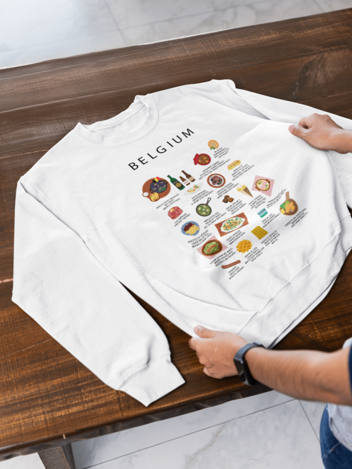 White Belgium food sweatshirt laid on a warm wooden bench in daylight