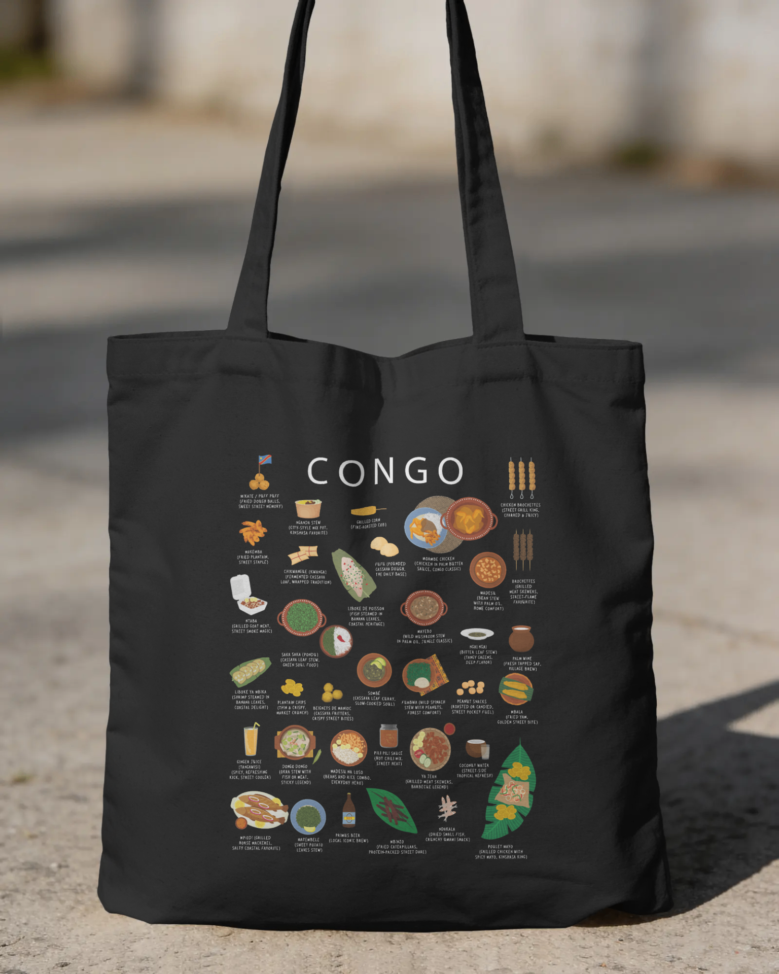 Black Congo food tote bag held on a sunlit street with soft focus background
