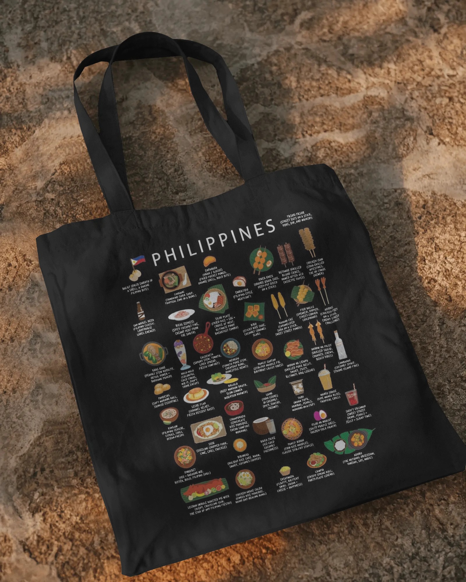 Black Philippines food tote bag styled on a warm stone surface