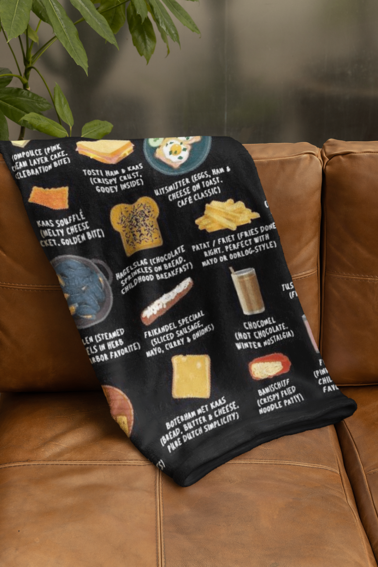 Netherlands plush fleece blanket draped over a caramel leather sofa