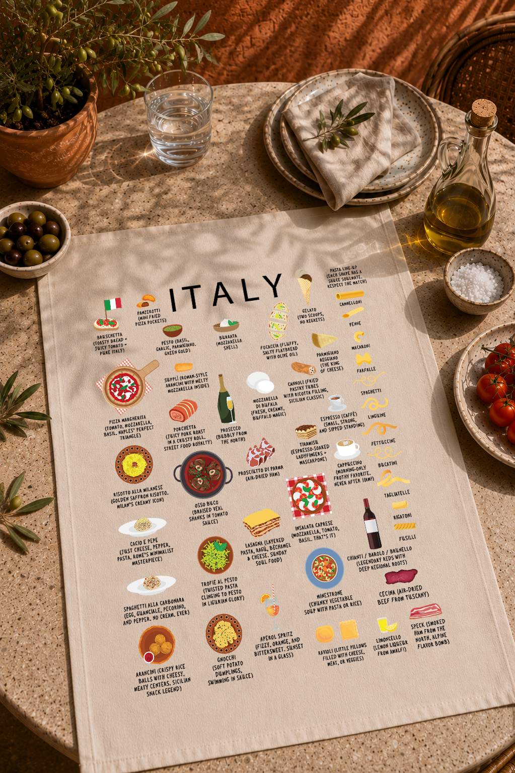Italy food tea towel styled on a sunlit Mediterranean table with olives, olive oil and tomatoes