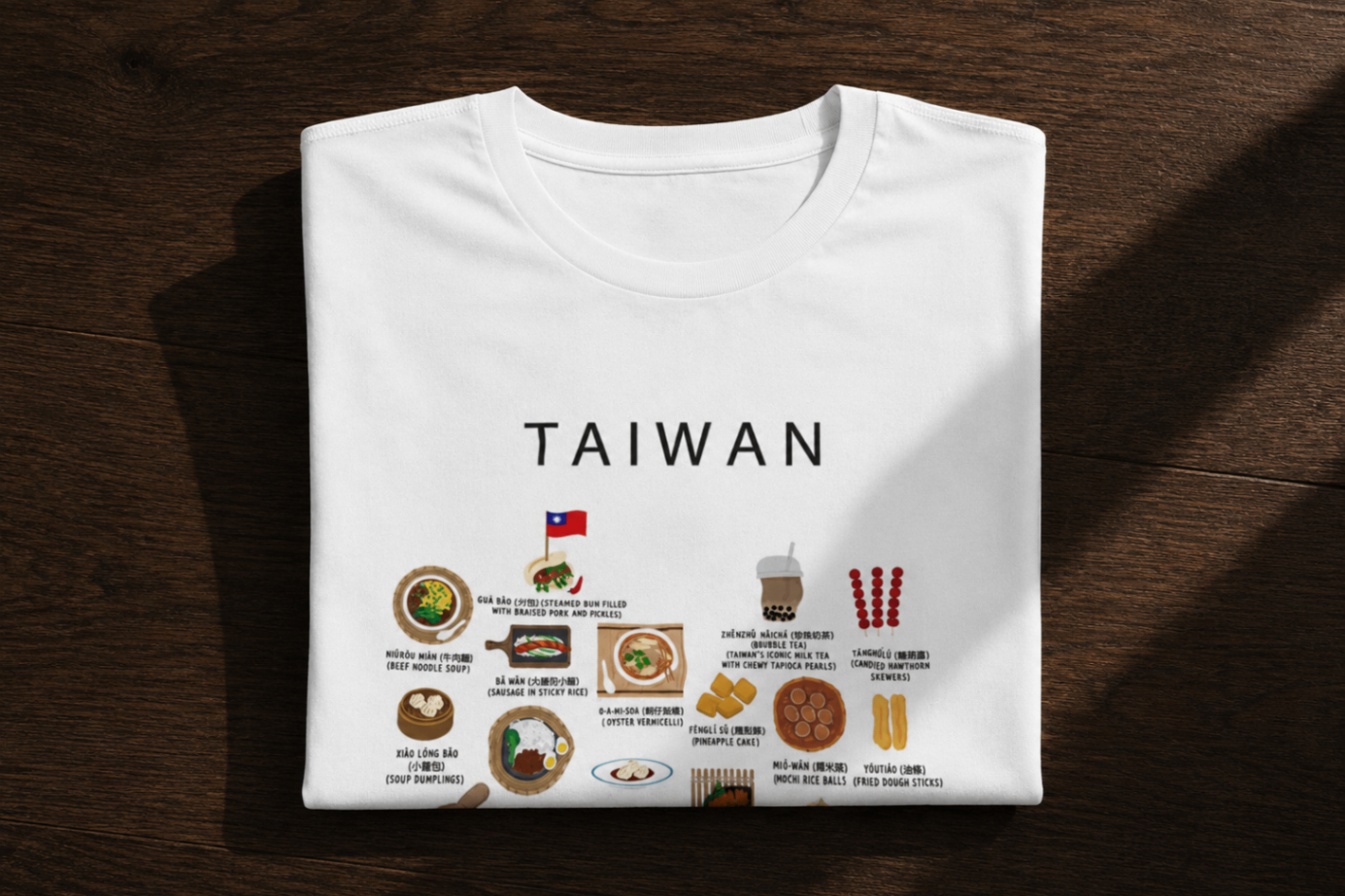White Taiwan food T-shirt folded neatly on a dark wooden surface