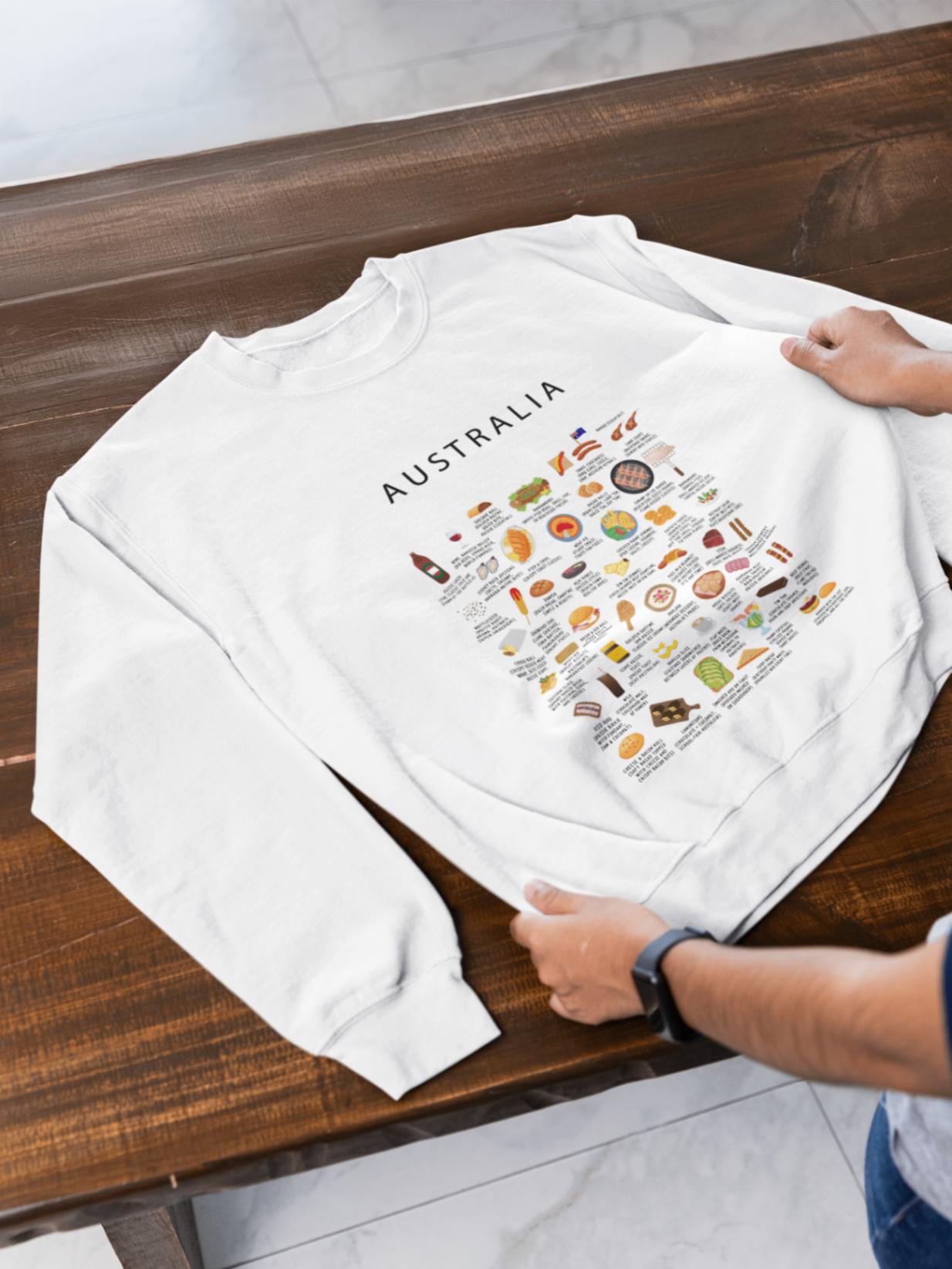 White Australia sweatshirt arranged on a rich wooden table