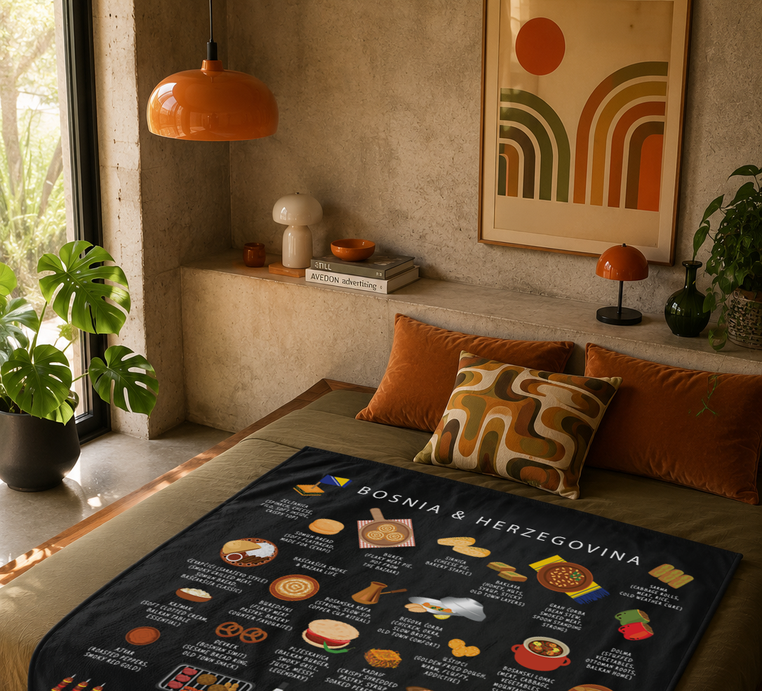 Black Bosnia & Herzegovina food blanket draped over a mossy green bed in a warm plaster-walled bedroom with orange velvet cushions
