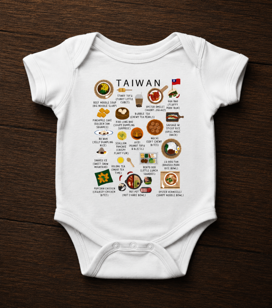 White Taiwan baby romper photographed flat on a dark wooden surface