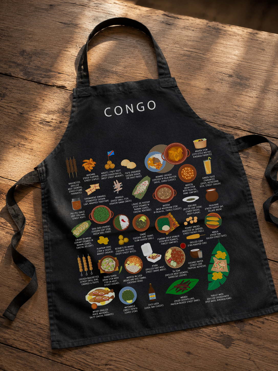 Black Congo food apron laid on a warm wooden floor in soft directional light
