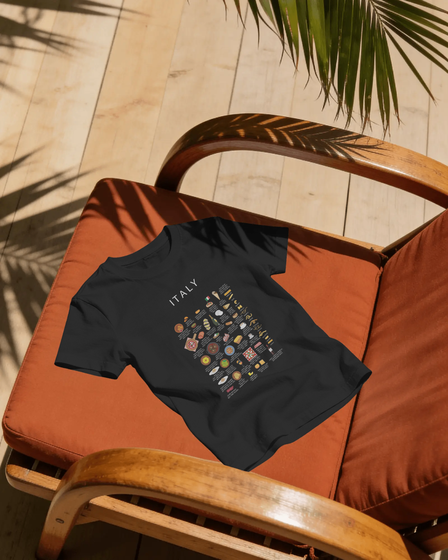 Black Italy food t-shirt styled on a terracotta cushioned chair