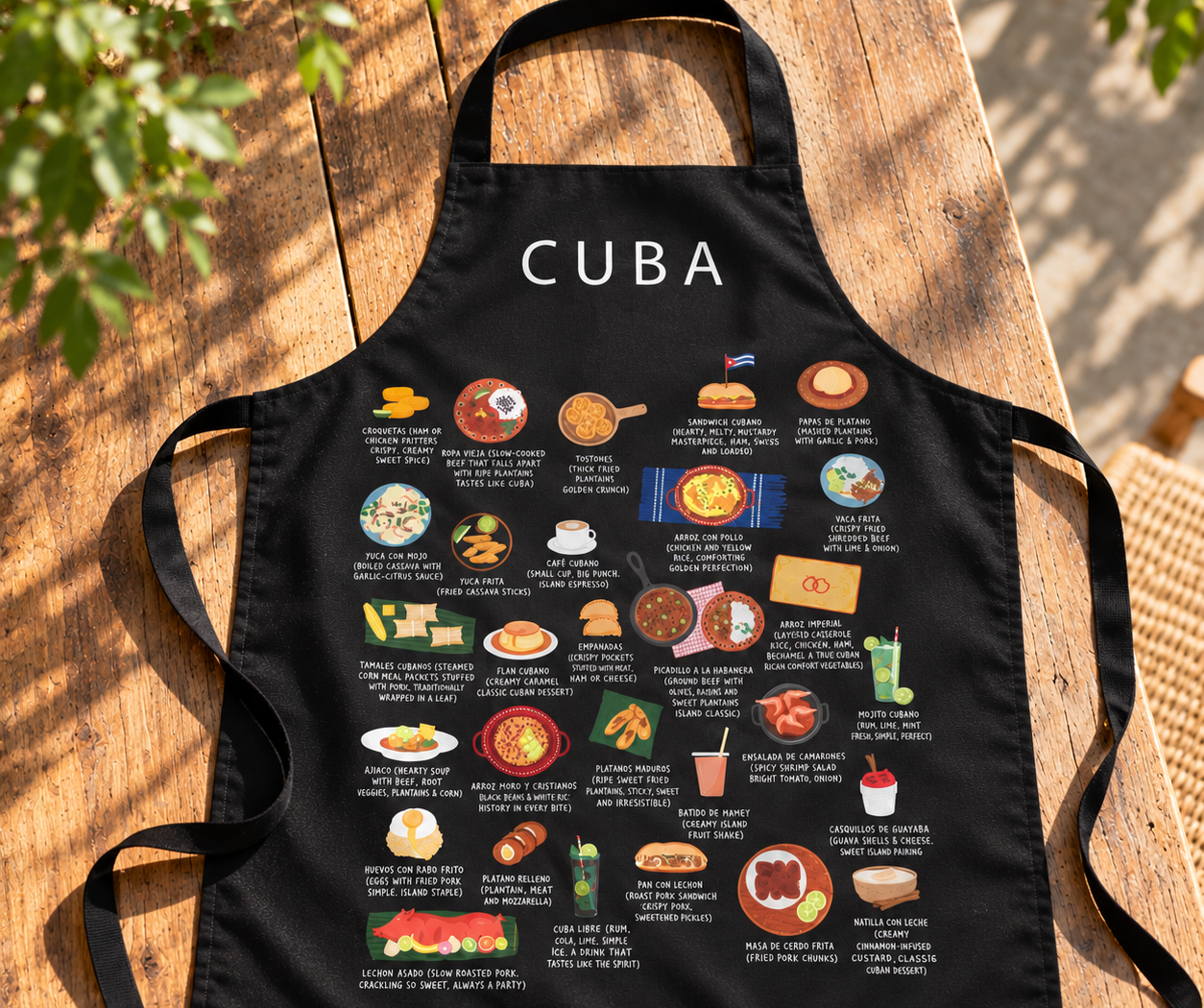 Black Cuba food apron laid on a wooden table in warm sunlight