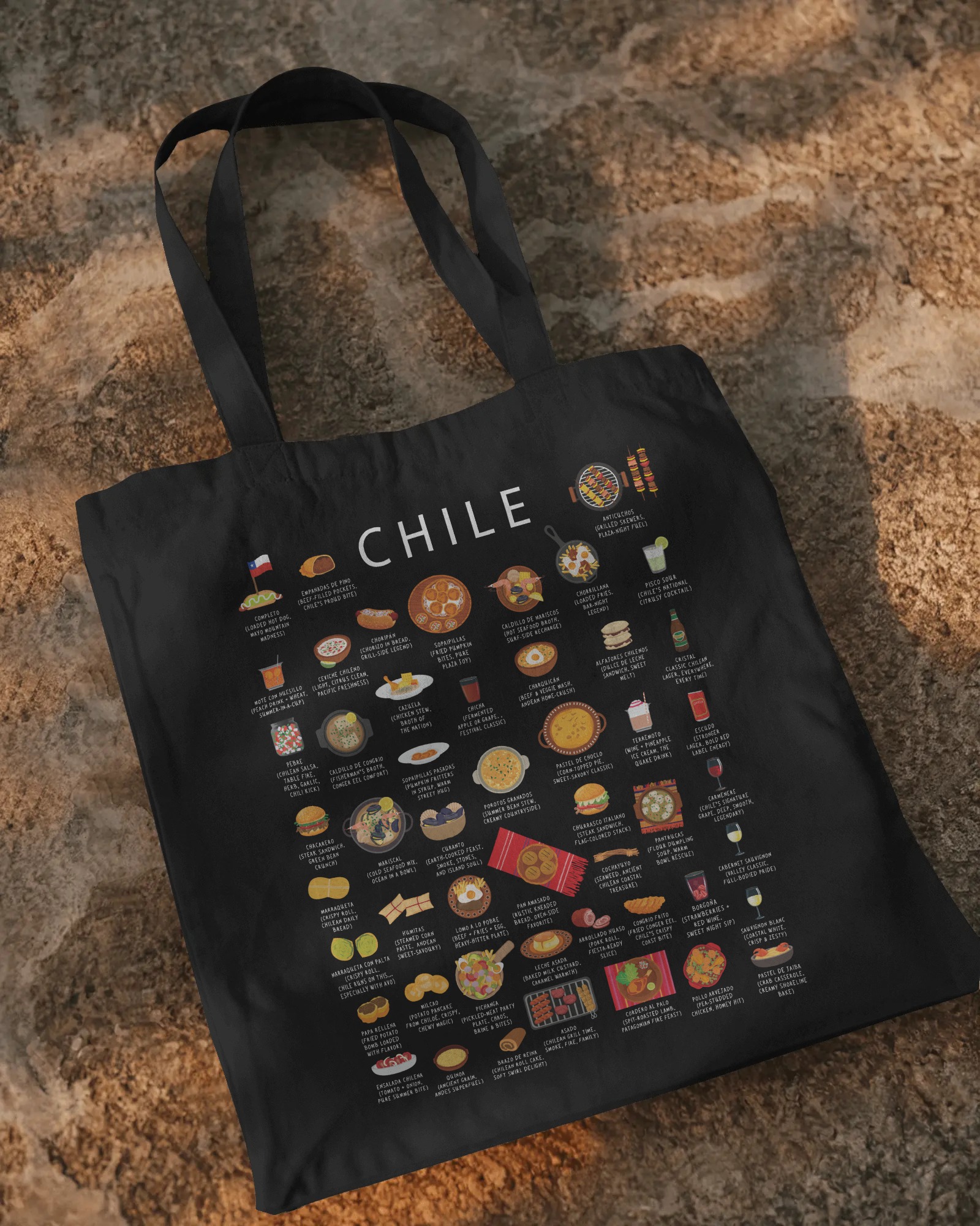 Black Chile food tote bag laid on a warm stone background