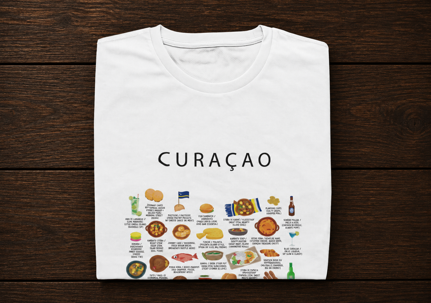 White Curaçao food T-shirt folded on a dark timber surface