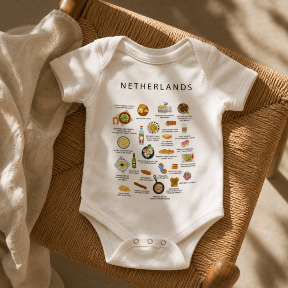 White Netherlands baby romper placed on a woven chair in warm light