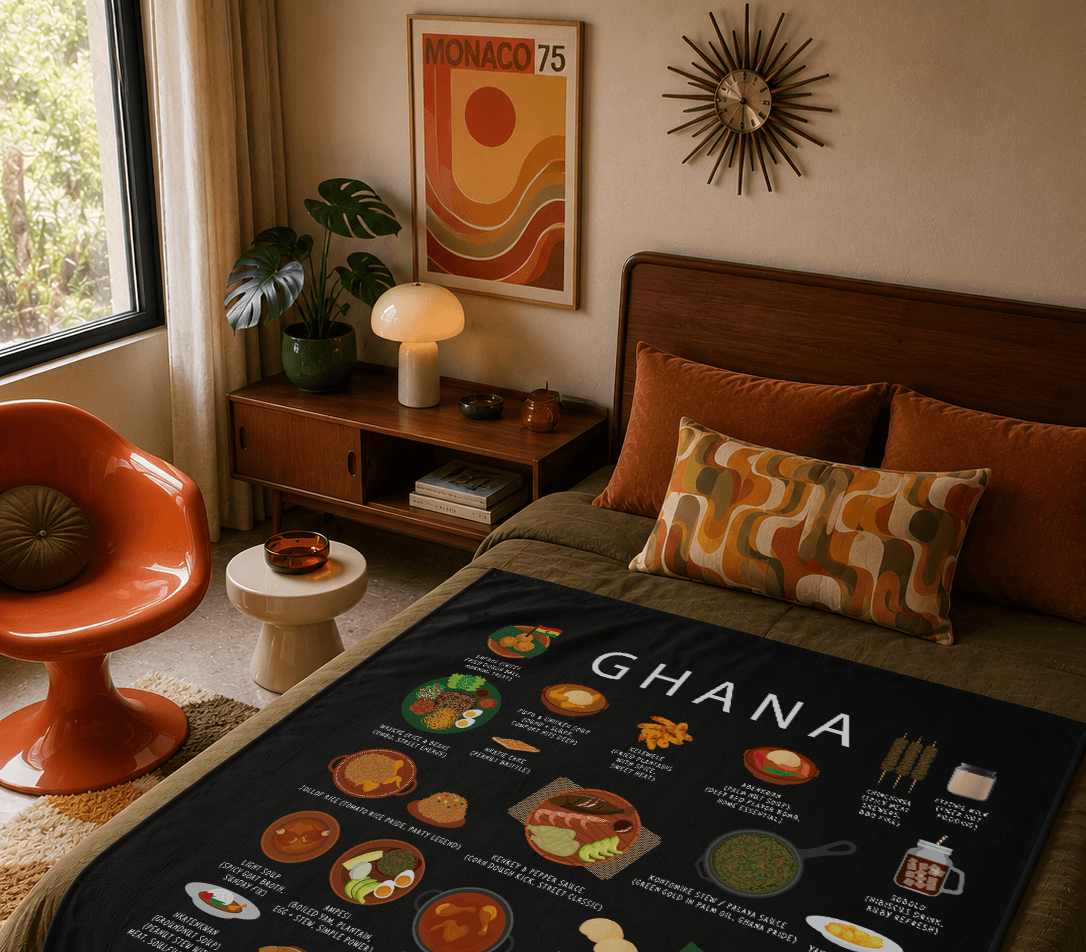 Black Ghana food blanket draped over a bed in a warm mid-century bedroom with orange velvet cushions